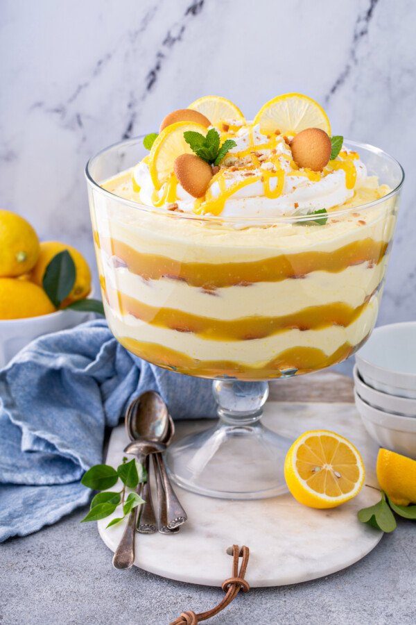Layered lemon pudding trifle with curd, sponge cake, and whipped cream