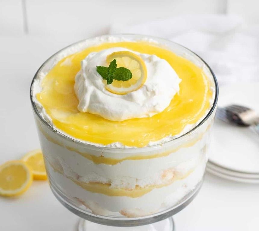 Elegant lemon cream trifle layered with curd, ladyfingers, and fresh berries