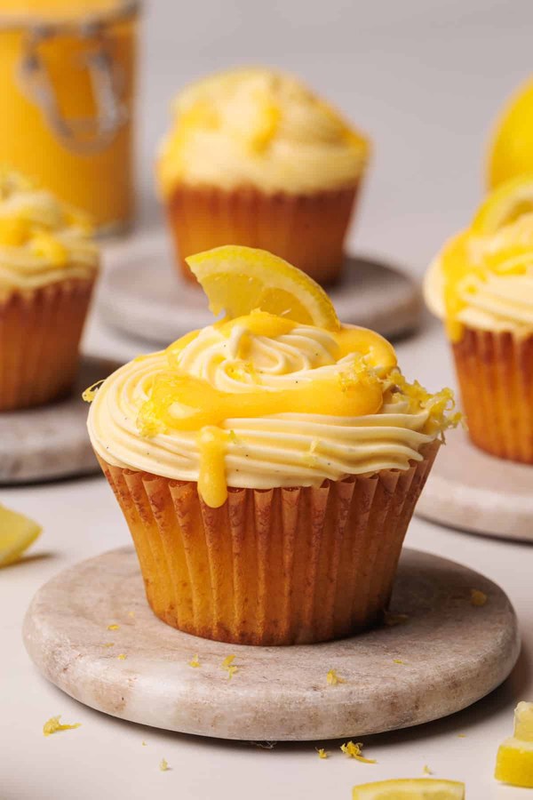 Two‑layer lemon cupcakes filled with lemon curd and topped with citrus frosting