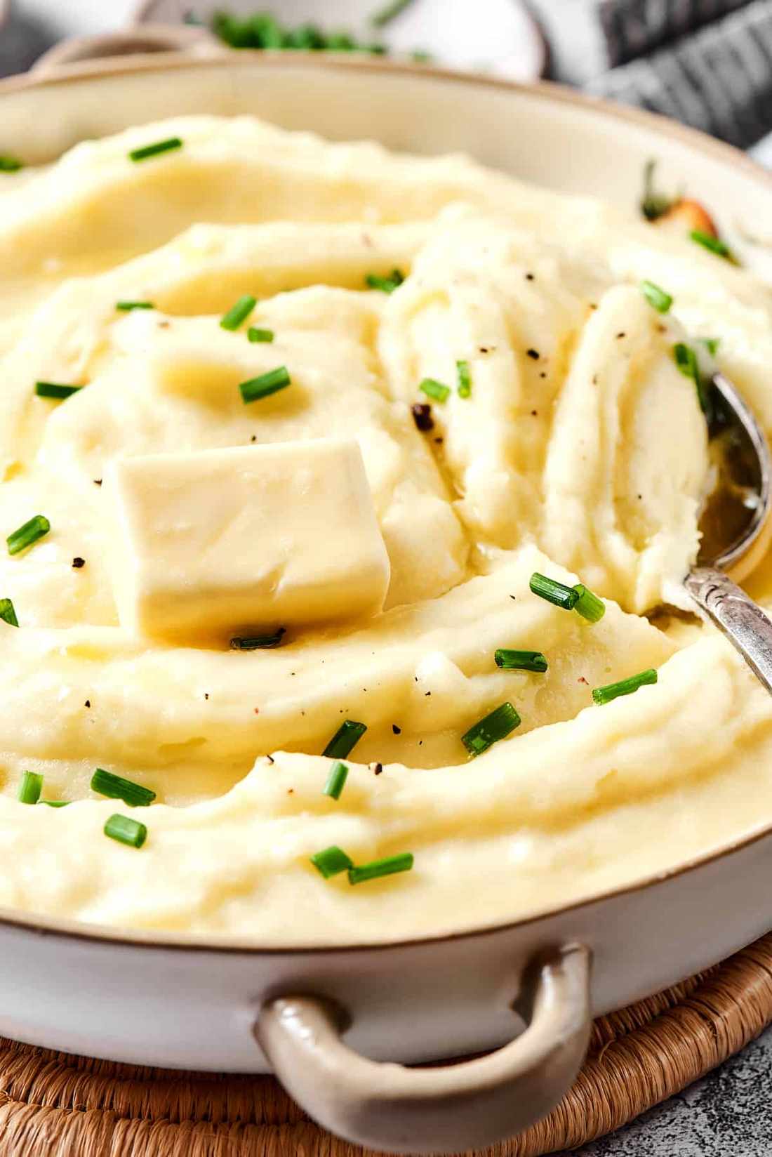 Golden brown butter buttermilk mashed potatoes topped with toasty speckled butter and fresh herbs