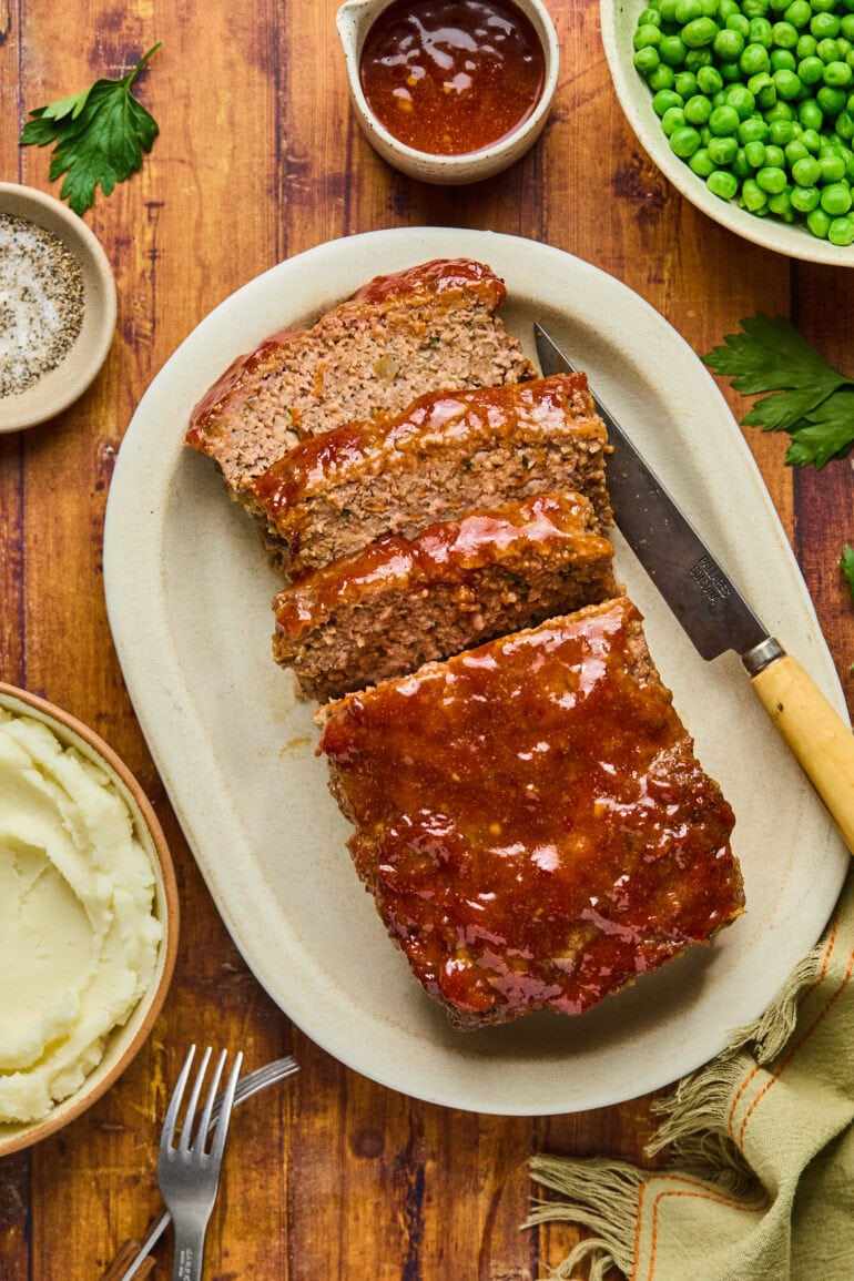 Classic beef meatloaf topped with herb-infused Parmesan crust, golden and crispy, inside tender and juicy