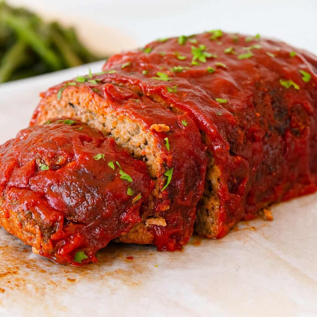 Classic beef meatloaf crowned with rich mushroom gravy, juicy interior, comforting family dinner
