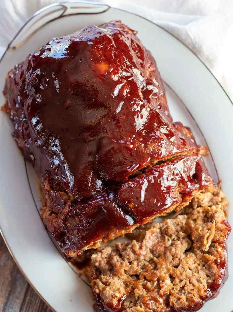 Juicy BBQ meatloaf with sweet smoky glaze, golden crust, and tender interior