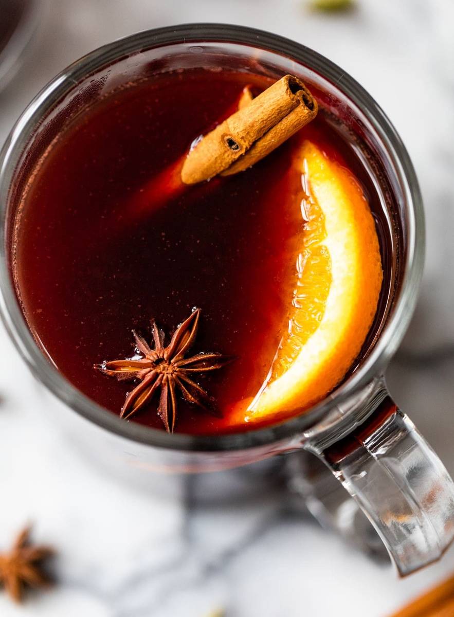 Slow cooker spiced red wine infused with thick cinnamon sticks and maple syrup with citrus