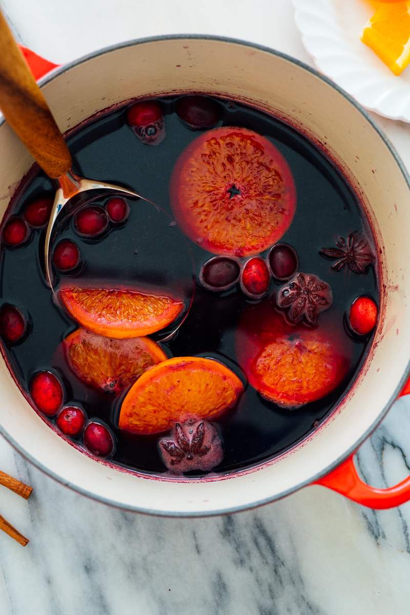 Traditional German Glühwein classic red mulled wine in festive mug with orange slice and cloves