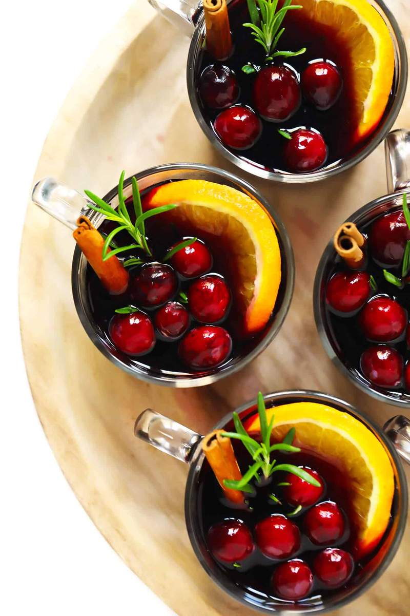 Cranberry mulled wine with clementine slices and fresh cranberries in festive holiday glassware