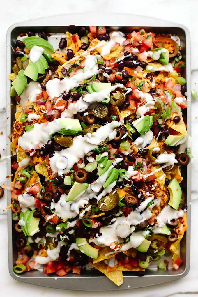 Veggie nachos with guacamole, melted pepper jack cheese, jalapeños, cool sour cream, and crispy tortilla chips.