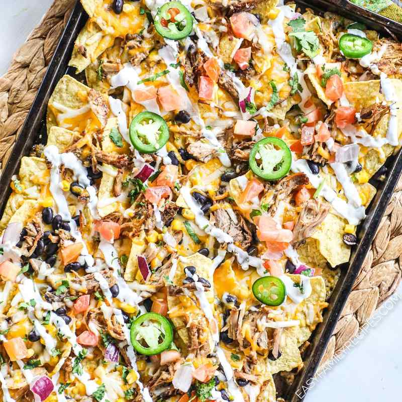 Carnitas pork nachos with melted pepper jack cheese, jalapeños, tangy guacamole, sour cream, and loaded tortilla chips.