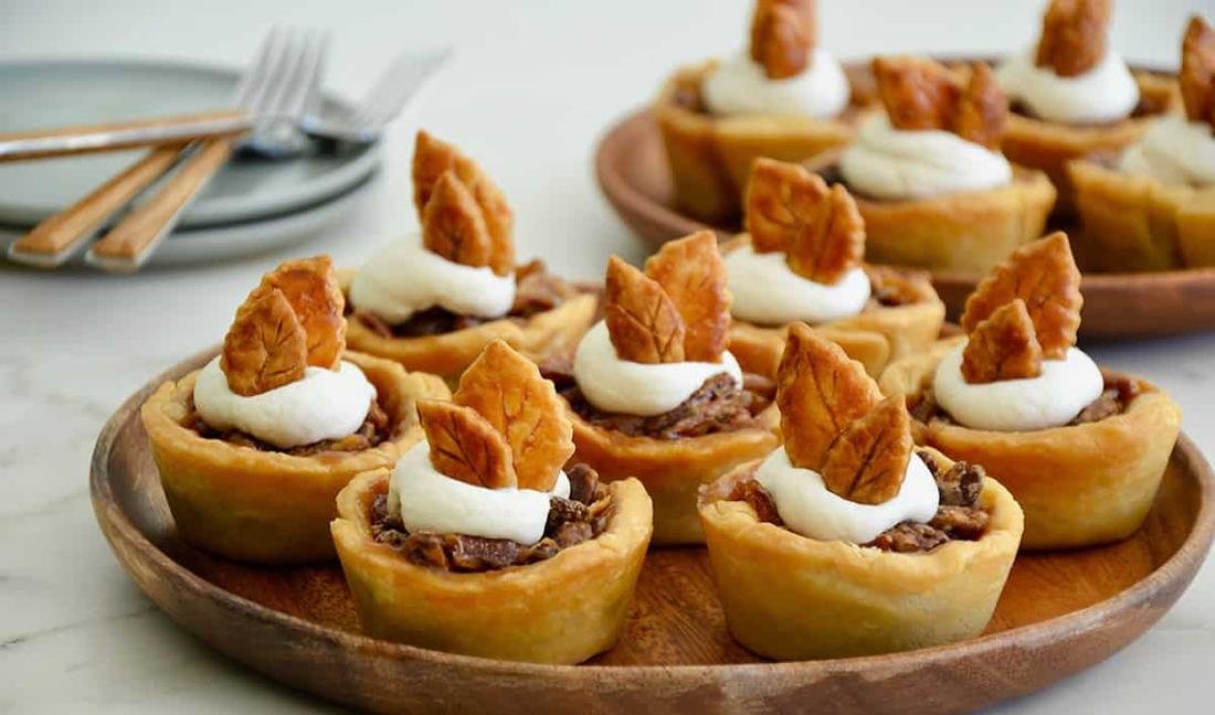 Rustic mini pecan pies baked in individual mini cast-iron skillets