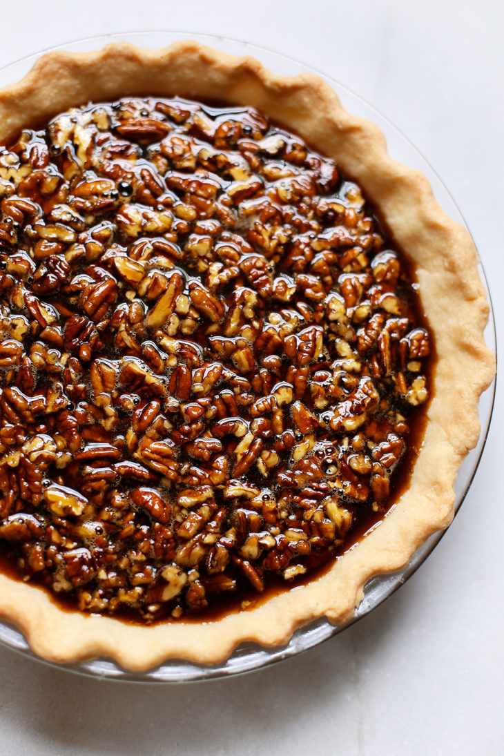 Decadent brown butter bourbon pecan pie slice with golden caramel filling and toasted pecans