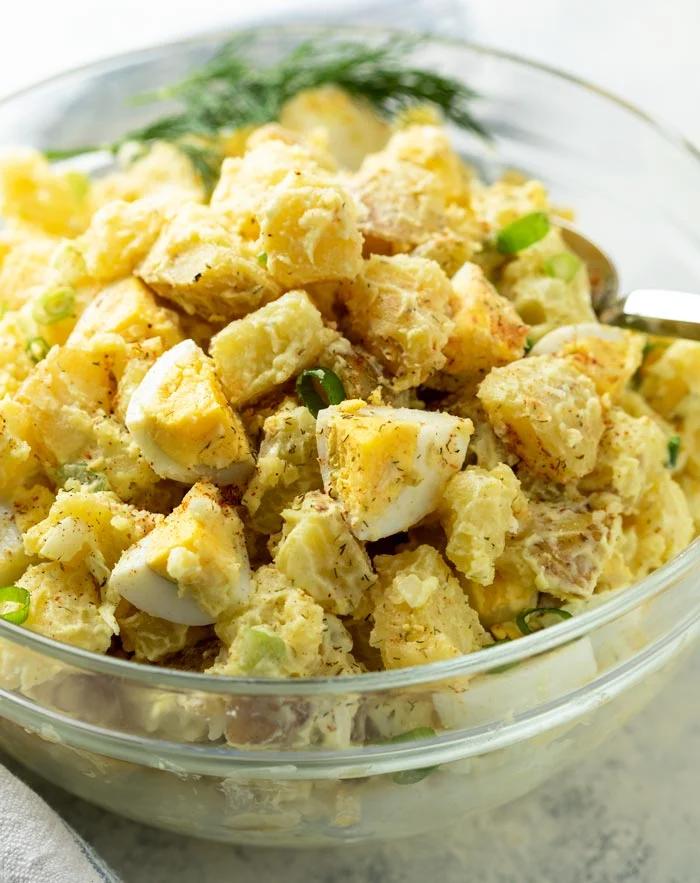 Classic creamy potato salad with tender potatoes, silky dressing, fresh herbs, and crunchy celery
