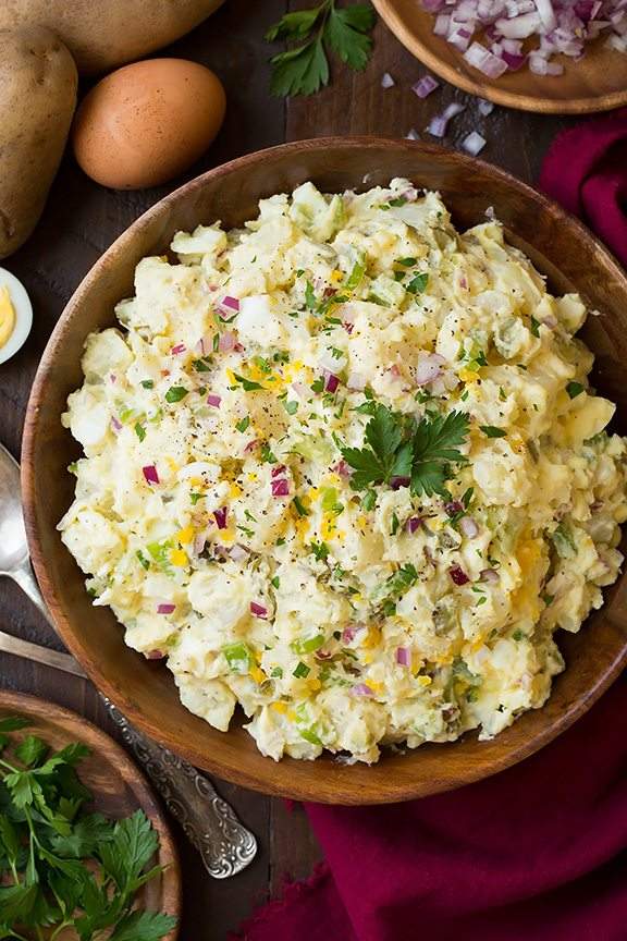 Classic creamy potato salad with tender potatoes, silky dressing, fresh herbs, and crisp celery