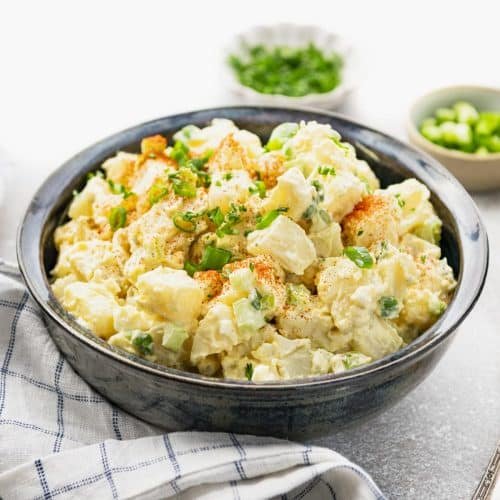 Southern potato salad with eggs, buttery potatoes, tangy mustard dressing, chopped boiled eggs, and fresh green onions