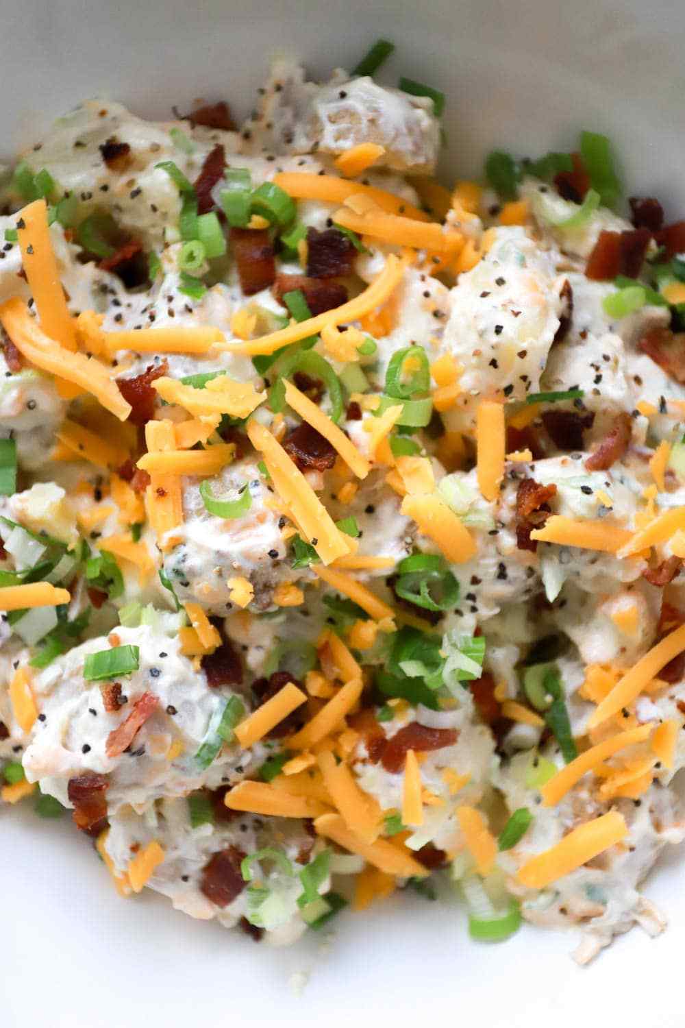 Classic creamy potato salad with tender potatoes, silky dressing, fresh herbs, and crunchy celery