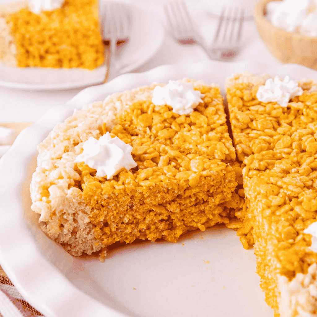 Golden Rice Krispie squares swirled with orange pumpkin puree and topped with candy “bones.”