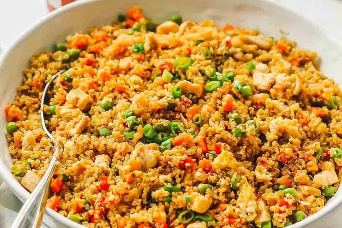 Spicy chicken quinoa fried rice with fluffy grains, fiery chili, and soy glaze