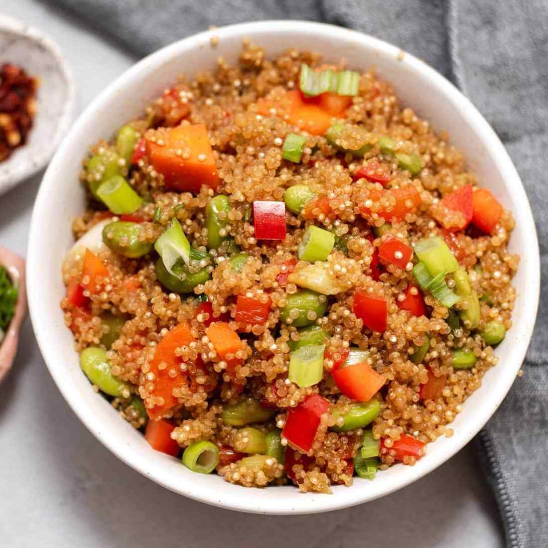Rainbow veggie quinoa fried rice featuring fluffy quinoa, colorful veggies, and a savory soy glaze