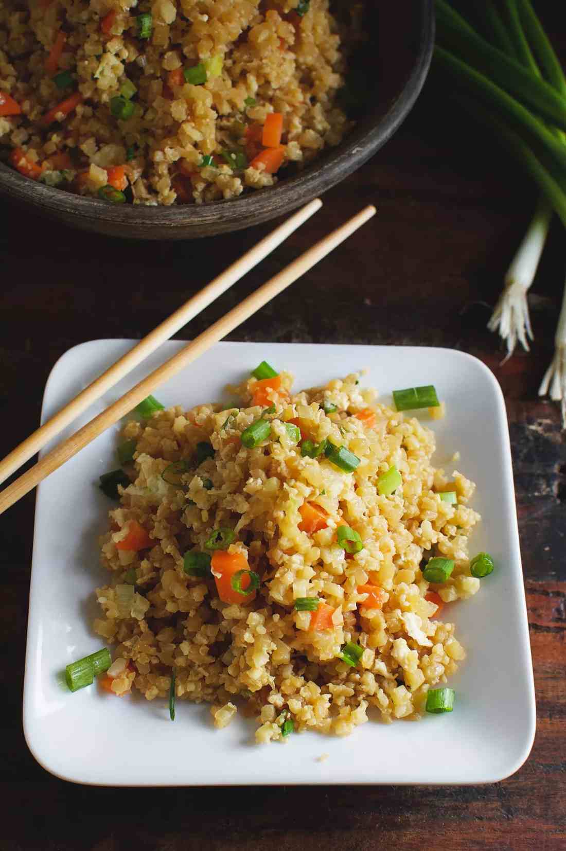 Colorful veggie quinoa fried rice with fluffy grains, crisp carrots, peas, and a soy glaze.