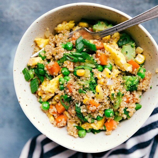 Sweet and spicy quinoa fried rice with chili flakes and colorful veggies.