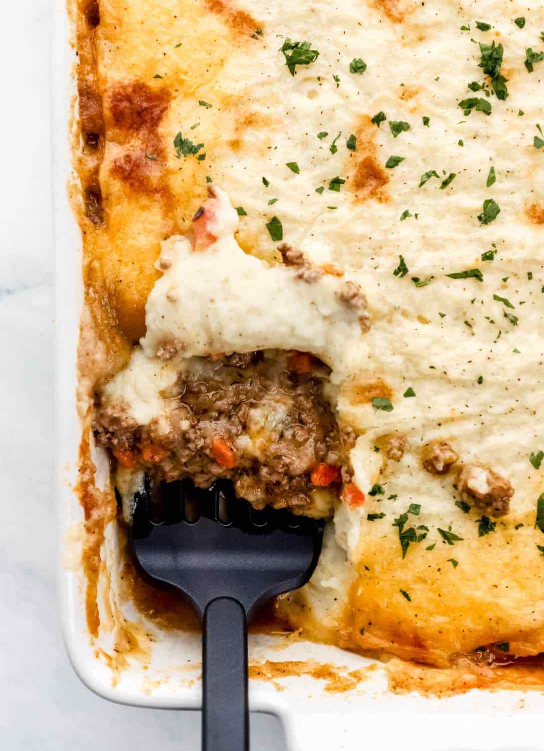 Traditional shepherd's pie, crispy butter‑mashed topping, savory lamb filling, bubbling cheese, warm casserole dish