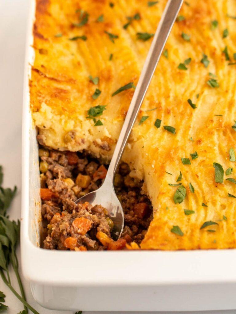 Golden mashed potato crowned ground beef cottage pie with savory filling, bubbling cheese, warm casserole