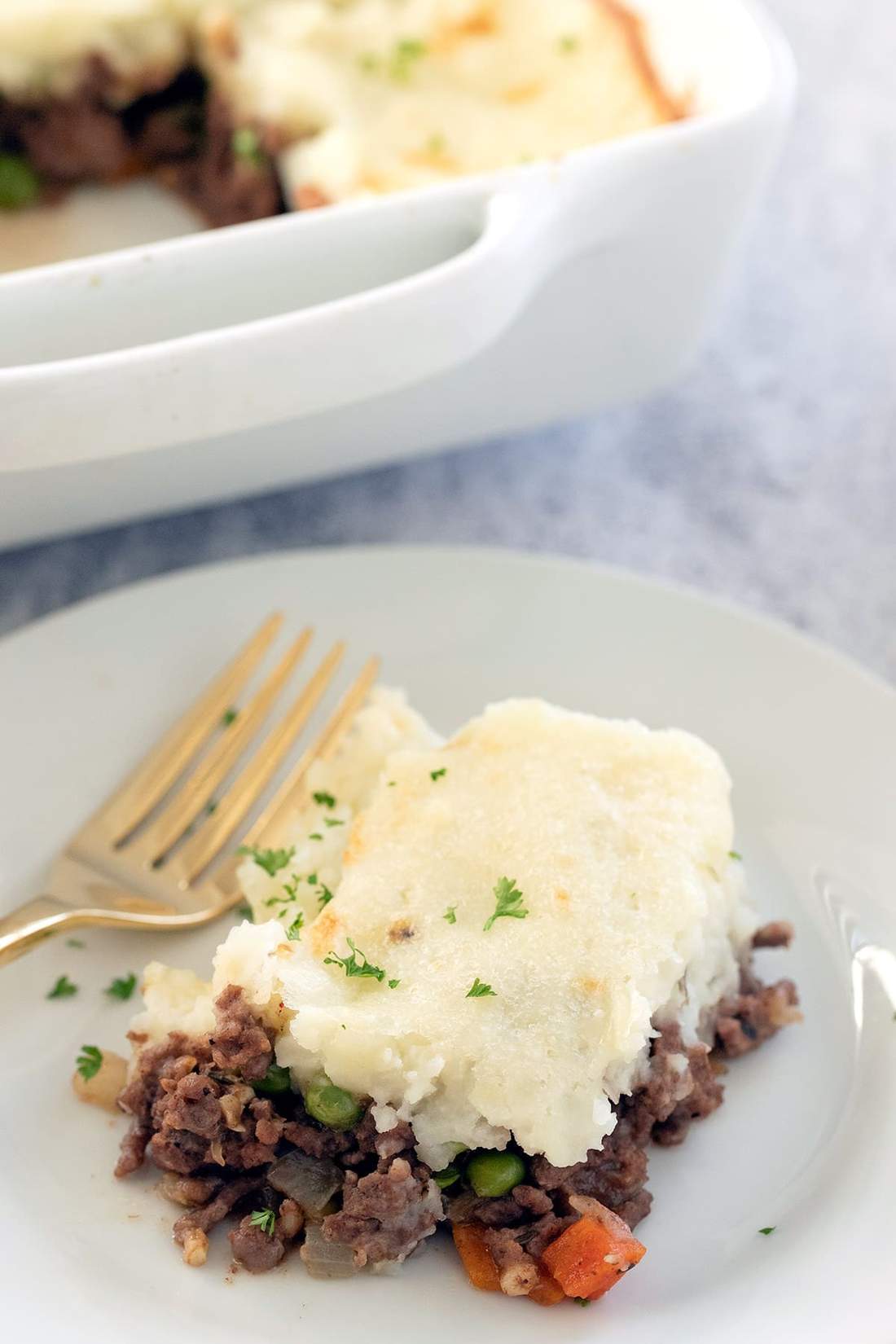 Golden mashed potato‑topped homestyle shepherd’s pie with savory lamb filling, bubbling cheese, warm casserole