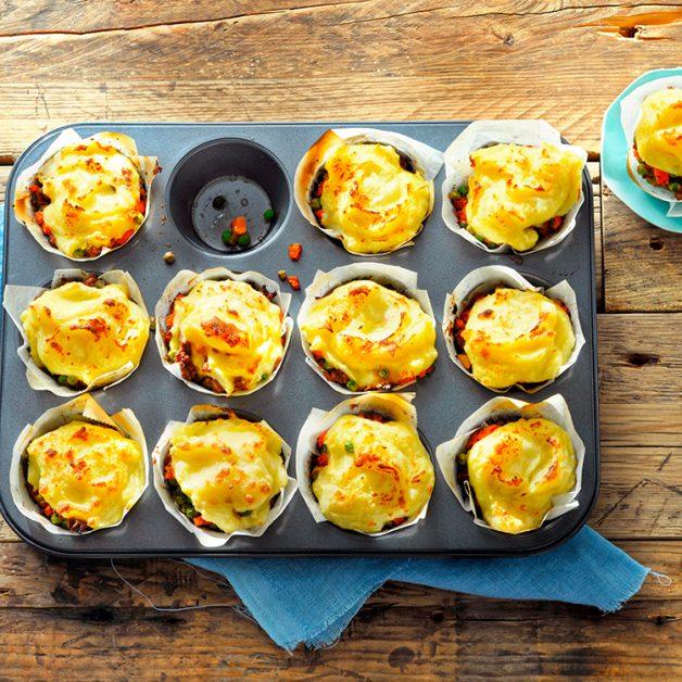 Golden mashed potato‑topped mini shepherd’s pies with savory beef filling, bubbling cheese, warm casserole