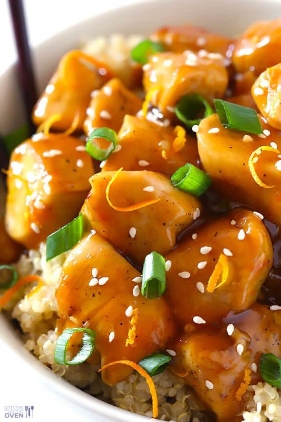 Skewered chicken pieces glazed with orange sauce, garnished with fresh orange segments