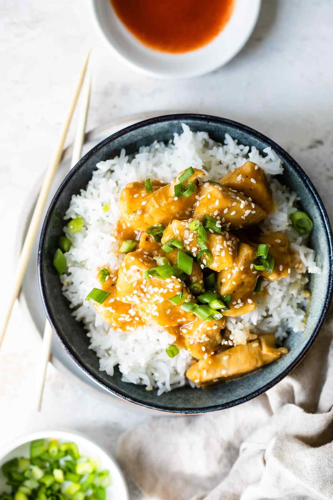 Chicken glazed in orange sauce served with colorful bell pepper strips, garnished with fresh orange zest