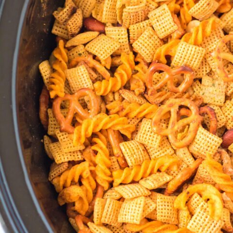 Double‑crunch Chex mix with pretzel twists, almonds, butter glaze, and savory herbs