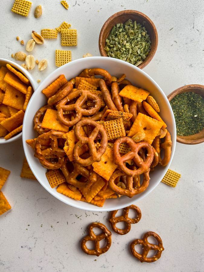 Mouth-watering spicy chex mix with crunchy Chex cereal, pretzels, nuts, fiery seasoning, and a golden glaze