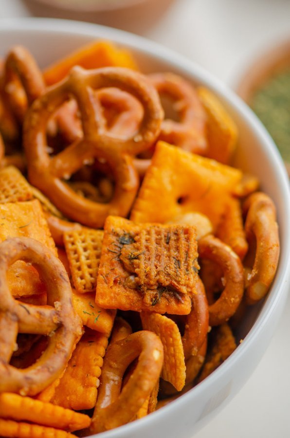 Spicy chex mix with crunchy Chex cereal, pretzels, nuts, fiery seasoning, and a glossy glaze