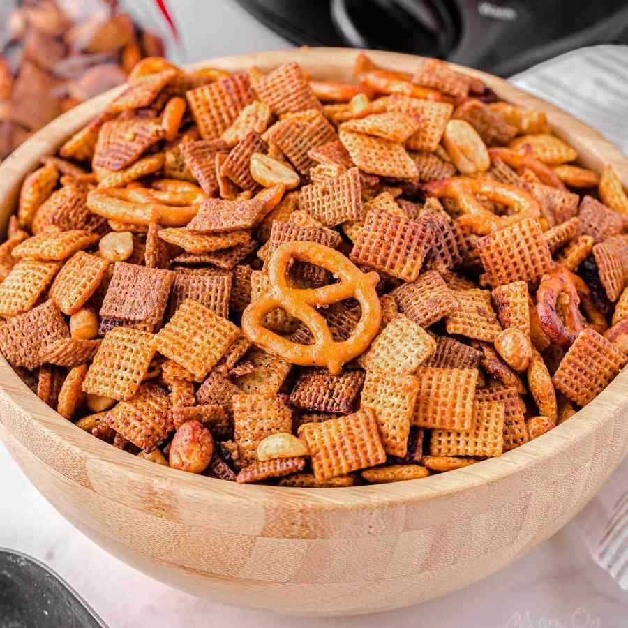 Classic slow cooker chex party mix with crunchy Chex cereal, pretzels, nuts, buttery coating, and savory seasoning