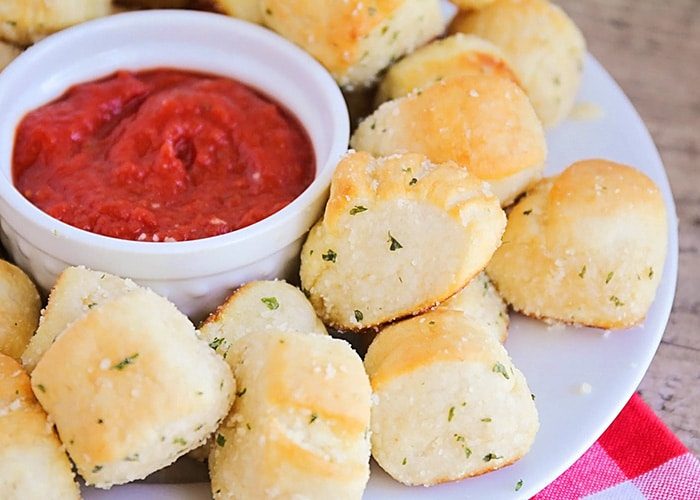 Cheesy garlic pretzel bites coated in Parmesan, served with a spicy jalapeño dip