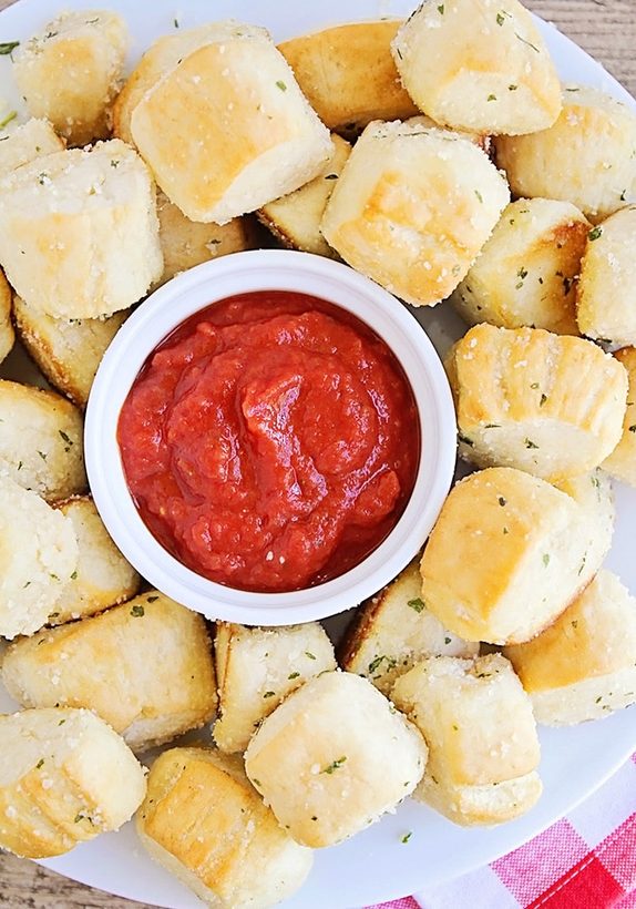 Triple‑cheese garlic parmesan pretzel bites dusted with mozzarella and cheddar, served with creamy ranch