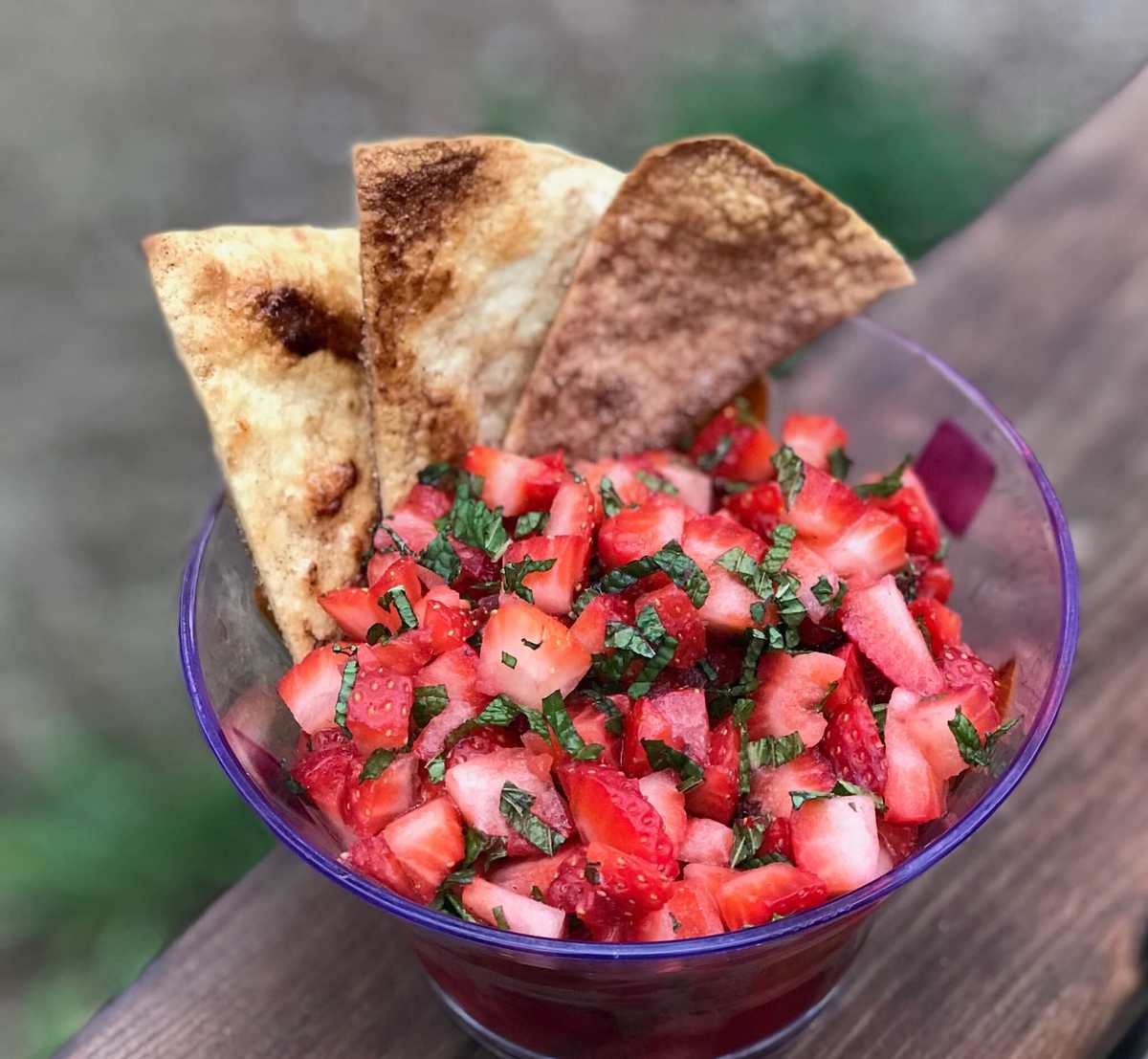 Sweet strawberry salsa accompanied by crisp cinnamon‑sugar crisps, orange zest, and fresh mint