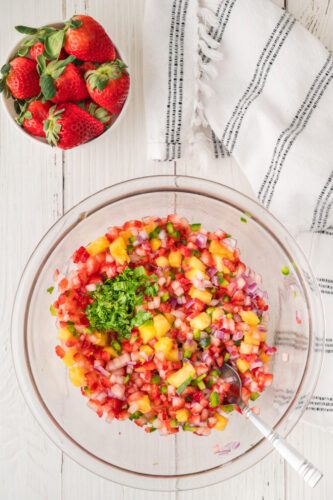Classic fresh strawberry salsa with strawberries, lime, cilantro, and a splash of orange juice