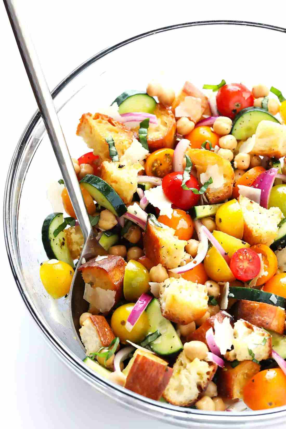 Classic summer panzanella with crusty bread cubes, ripe tomatoes, basil, mozzarella, and olive oil