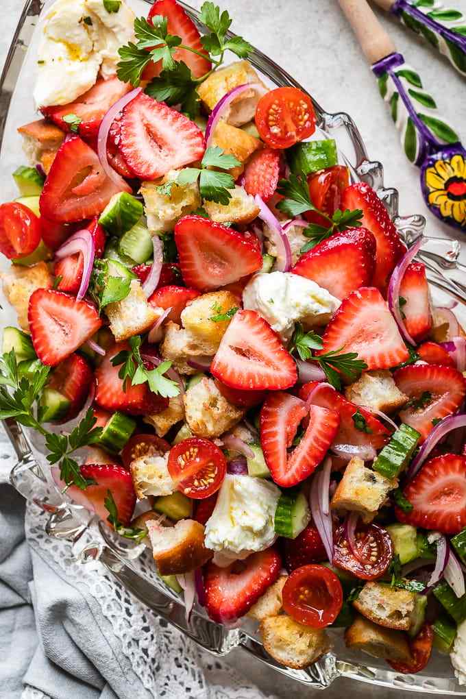 Classic summer panzanella with crusty bread cubes, ripe tomatoes, basil, mozzarella, and olive oil