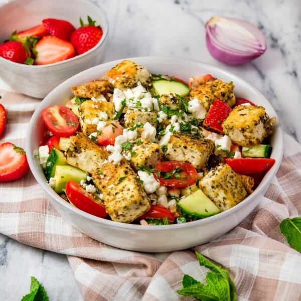 Classic summer panzanella with crusty bread cubes, ripe tomatoes, basil, mozzarella, and olive oil