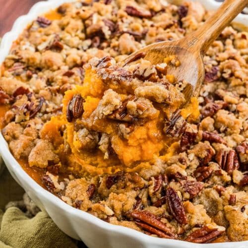 Bubbling sweet potato casserole topped with maple-glazed crunchy pecan streusel and melted butter