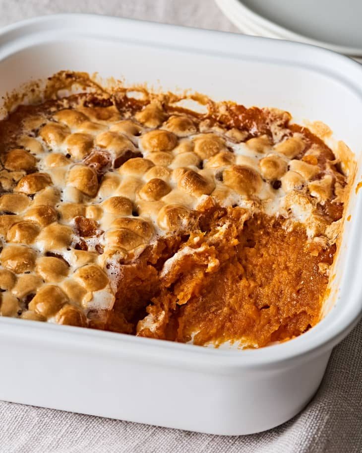 Creamy whipped classic sweet potato casserole speckled with vanilla bean and cinnamon in dish