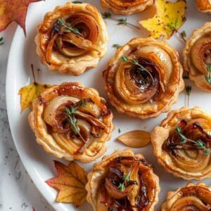 Mini tart shells filled with sweet caramelized onions and melted Gruyère cheese