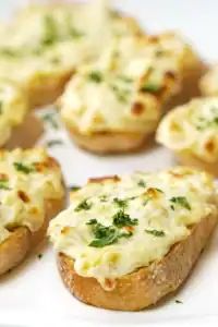 Crunchy baguette slices topped with garlic butter, mozzarella, and parmesan