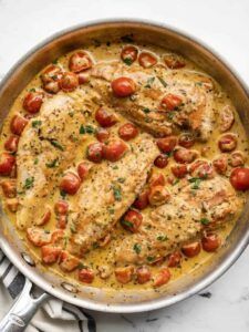 Golden chicken morsels in a creamy garlic sauce, garnished with parsley
